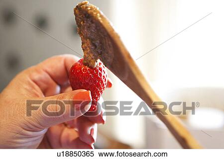 Stock Photography - Chocolate Dripping onto Strawberry. Fotosearch