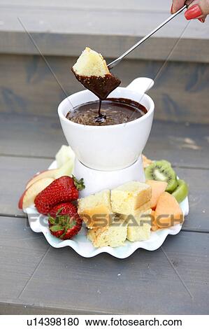 Stock Image - Chocolate Fondue with Orange Blossom Pound Cake. Fotosearch
