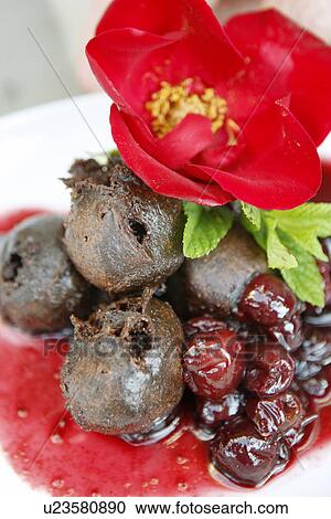 Stock Image - Chocolate Truffle Fritters with Cherry Sauce. Fotosearch