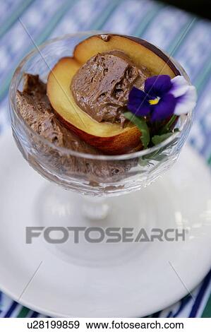 Stock Photo - Chocolate Zabaglione Served with a Peach. Fotosearch
