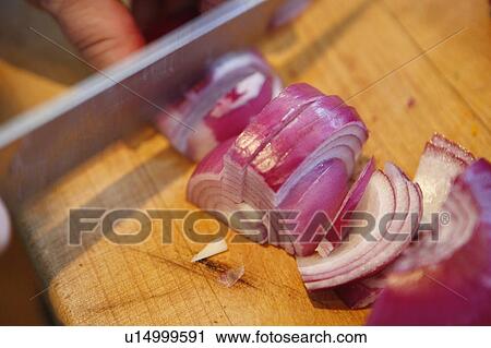 Stock Image - Chopping Red Onion. Fotosearch