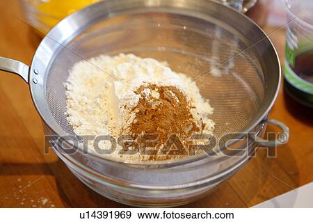 Stock Photo - Cocoa Powder and Flour in Sieve / Baking ingredients. Fotosearch
