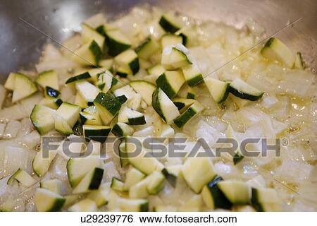 Stock Photograph - Courgette and Onion in Pan. Fotosearch