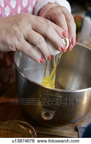 Stock Photo - Cracking an Egg / step shot. Fotosearch