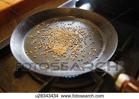 Picture - Cumin Seeds in Pan. Fotosearch