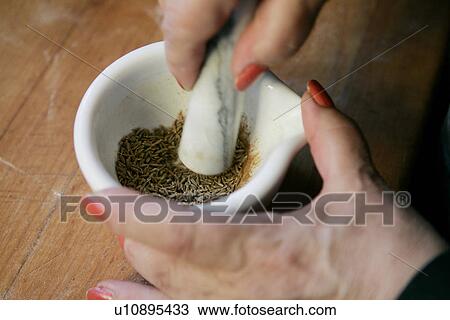 Stock Image - Cumin Seeds with Pestle and Mortar. Fotosearch