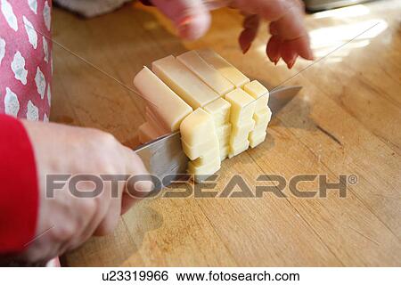 Stock Photograph - Cutting Cheese. Fotosearch