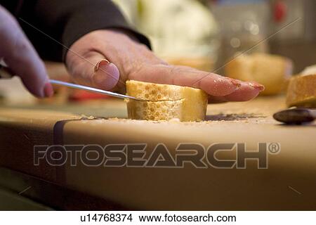 Picture - Cutting French bread. Fotosearch