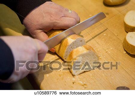 Stock Photograph - Cutting French Loaf. Fotosearch