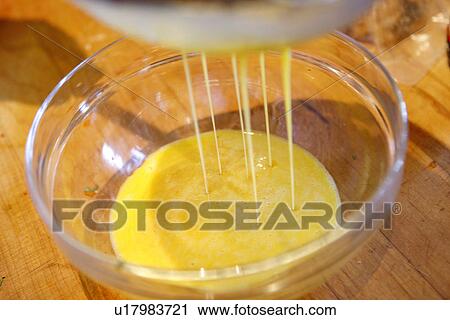 Egg dripping into bowl View Large Photo Image Stock Image - Egg dripping into bowl. Fotosearch