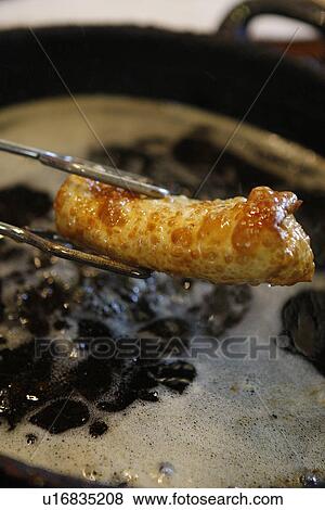 Egg roll in Oil in pan View Large Photo Image Stock Photo - Egg roll in Oil in pan. Fotosearch