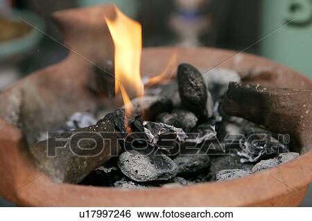 Stock Photograph - Fire and Coals in Tagine. Fotosearch