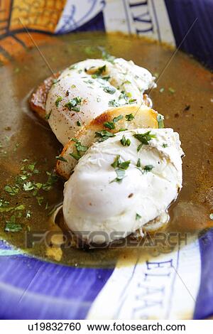 Stock Image - Garlic Soup with Poached Eggs. Fotosearch