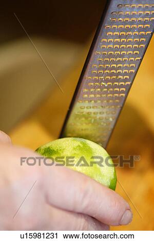 Stock Image - Grating Lemon. Fotosearch