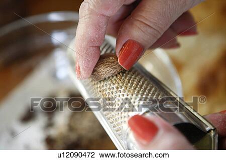 Stock Image - Grating Nutmeg. Fotosearch