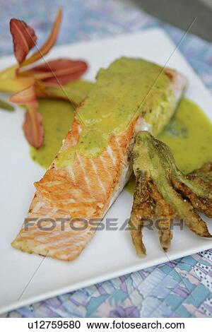 Stock Image - Grilled Salmon with Zucchini Curry Sauce. Fotosearch