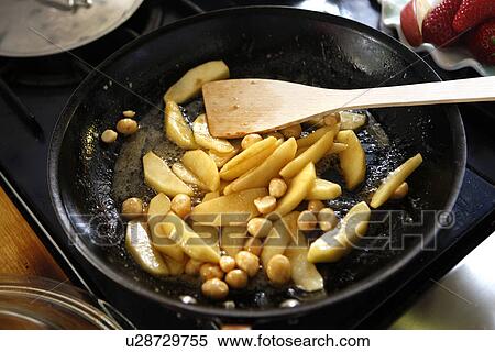 Stock Photography - Macadamia Nuts and Potatoes in Pan. Fotosearch