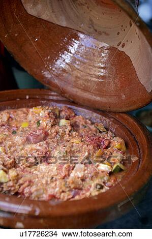 Picture - Moroccan Tajine of Eggs baked over vegetables. Fotosearch