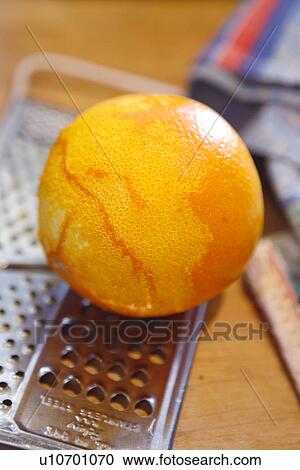 Stock Image - Orange and Grater. Fotosearch