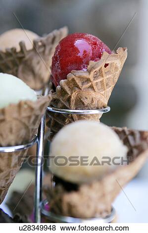 Stock Photo - Raspberry Sorbet and other varieties in waffle cones. Fotosearch