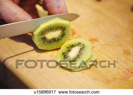 Stock Photo - Slicing a Kiwi Fruit. Fotosearch