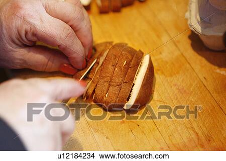 Picture - Slicing a Shiitake Mushroom. Fotosearch