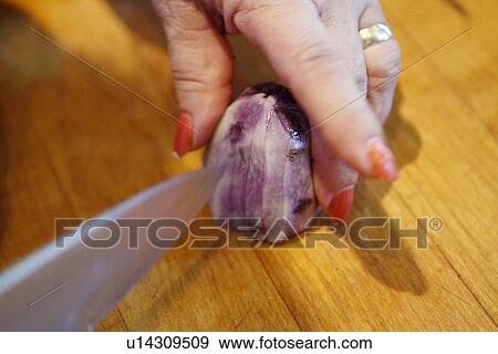 Stock Photo - Slicing Peruvian Blue Potato. Fotosearch
