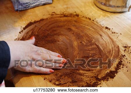 Spreading Cocoa on kitchen counter View Large Photo Image Stock Image - Spreading Cocoa on kitchen counter. Fotosearch