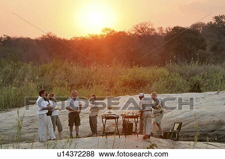 Stock Photo - Sundowners in the Wild in South Africa. Fotosearch