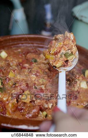 Stock Photo - Tajine of Eggs baked over vegetables. Fotosearch