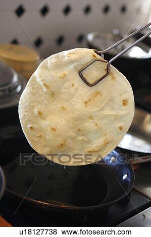Tortilla and Tongs View Large Photo Image Stock Photo - Tortilla and Tongs. Fotosearch