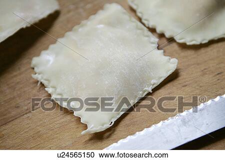 Stock Image - Uncooked Home-Made Ravioli /Step shot. Fotosearch