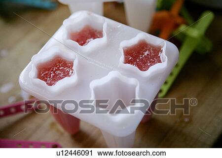 Stock Image - Watermelon Ice pop Preparation / step shot. Fotosearch
