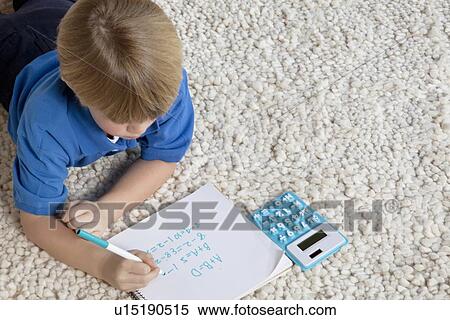 Blond boy doing lying on rug doing homework View Large Photo Image Stock Photography - Blond boy doing lying on rug doing homework. Fotosearch