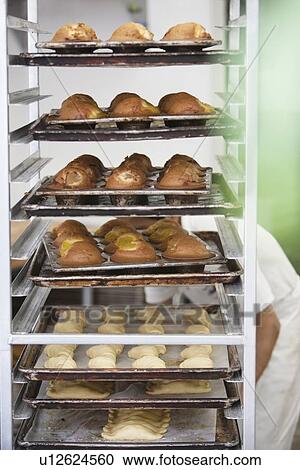 Stock Image - Bread cart with baker in background. Fotosearch