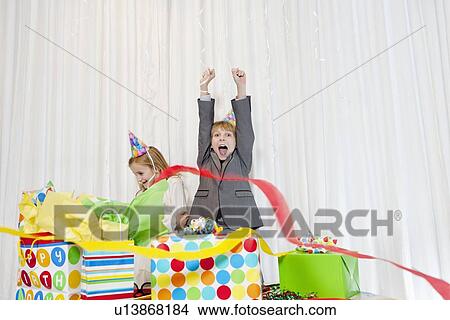 Brothers and sister enjoying at birthday party View Large Photo Image Picture - Brothers and sister enjoying at birthday party. Fotosearch