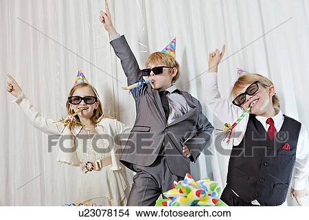 Brothers and sister wearing sunglasses and party puffer in mouth dancing View Large Photo Image Picture - Brothers and sister wearing sunglasses and party puffer in mouth dancing. Fotosearch