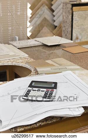 Stock Photo - Calculator on paper in tiles store. Fotosearch