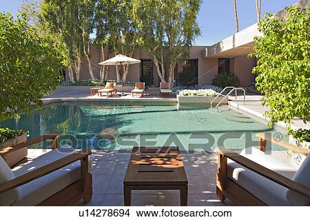 Picture - Chaise lounge at poolside in manor house. Fotosearch