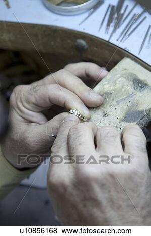 Close-up of a mature man repairing ring View Large Photo Image Stock Photo - Close-up of a mature man repairing ring. Fotosearch