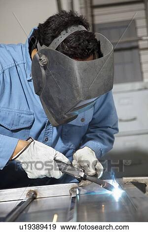 Close-up of young male welding in workshop View Large Photo Image Stock Photo - Close-up of young male welding in workshop. Fotosearch