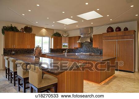 Stock Image - Contemporary interior of kitchen with chairs in luxury manor house. Fotosearch