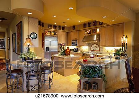 Stock Image - Contemporary kitchen with table and chair in manor house. Fotosearch
