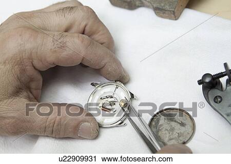 Cropped image of hands repairing watch View Large Photo Image Stock Image - Cropped image of hands repairing watch. Fotosearch