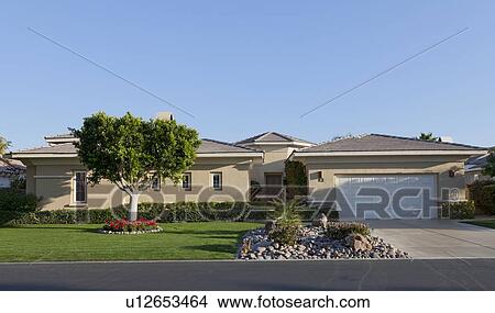 Picture - Front of house with lawn and driveway. Fotosearch