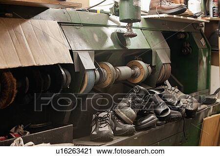 Stock Image - Group of shoes by polishing machinery. Fotosearch