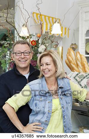 Happy mature couple in cake shop View Large Photo Image Stock Photography - Happy mature couple in cake shop. Fotosearch