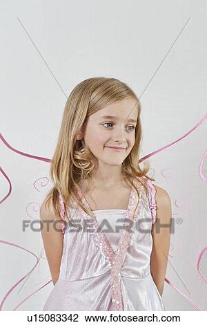 Happy young girl with hands behind back over colored background View Large Photo Image Stock Image - Happy young girl with hands behind back over colored background. Fotosearch