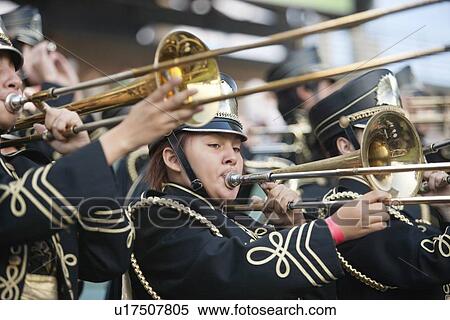 Stock Photography - High school marching band playing trombone. Fotosearch