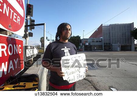 Homeless person with placard standing on street View Large Photo Image Picture - Homeless person with placard standing on street. Fotosearch